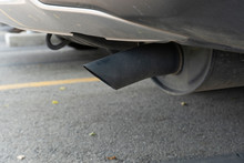 Close Up Exhaust Pipe Of Used Car. That May Cause Pollution On The Road.