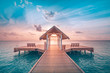Amazing sunset landscape. Picturesque summer sunset in Maldives. Luxury resort villas seascape with soft led lights under colorful sky. Dream sunset over tropical sea, fantastic nature scenery