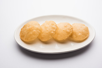 Wall Mural - Plain Puri served in a plate. It's an Indian deep-fried bread made from whole-wheat flour, popular main course or breakfast recipe 