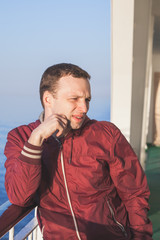 Wall Mural - Young Caucasian man standing on a walking deck