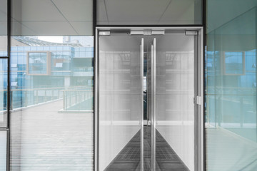 Poster - A modern office building with glass doors and windows