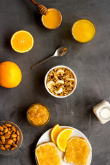 Wall Mural - Granola for healthy breakfast. Still life composition with fruits and toast on grey background top-down