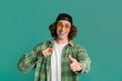 © Prostock-studio - Portrait of cool young guy in sunglasses pointing at you on color background