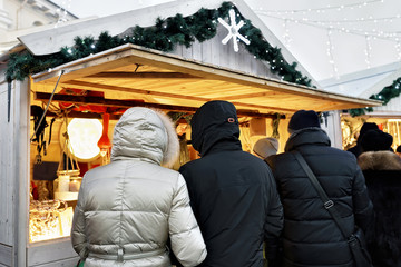 Poster - People at counter of Christmas market at Cathedral Square Vilnius