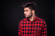 © Ranta Images - Young handsome Indian man against black background