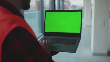 Wall Mural - Hands engineer man using laptop computer with green screen inside building worker project occupation builder technology mock-up professional male safety device computer slow motion