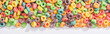 top view of bright multicolored breakfast cereal on white background, panoramic shot