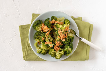 Boiled broccoli pieces covered with butter and breadcrumbs