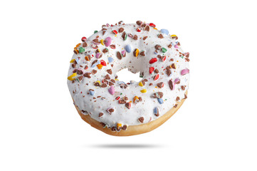  a fresh donut in white glaze is sprinkled with multi-colored dragees with a chock inside. isolate on white background