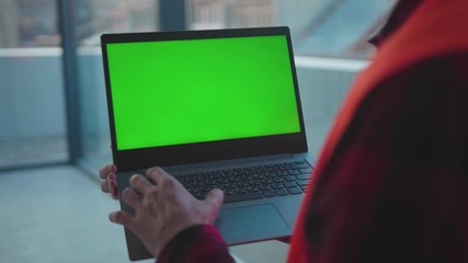 Wall Mural - Young hands engineer using laptop computer with green screen typing inside building worker project occupation builder technology mock-up professional male safety device computer slow motion