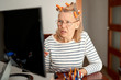 © JENOCHE - Pensioner middle aged in glasses using laptop typing email working at home office