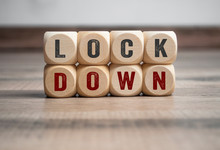 Cubes And Dice With Word Shutdown And Lockdown On Wooden Background