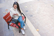 © Vicente Sargues - Young girl using her mobile on a bench