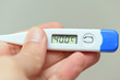 © 0meer - hand holding a thermometer with a high fever temperature of more than 40 celsius