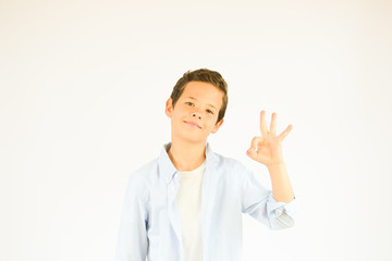 Happy boy making hand gesture