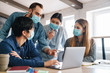 © Drobot Dean - Photo of multinational students in medical masks studying with laptop