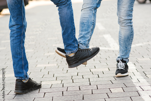 Cuadros en Lienzo Low section of men greeting each other with feet