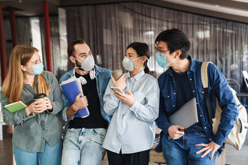 Poster - Photo of joyful students in medical masks talking while standing