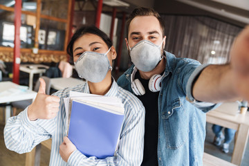 Sticker - Photo of students in medical masks taking selfie and showing thumb up