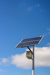 Solar panel on the post produces green, environmentally friendly sun energy