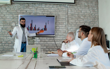  Doctors and medical researchers or scientists on conference meeting, discussing possible solutions for resolving a world health crisis. Health and medical care concept. Selective focus.