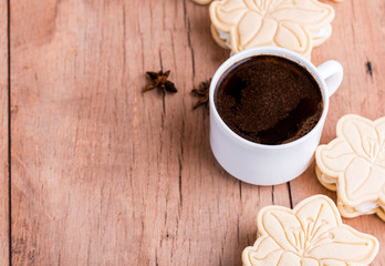 Wall Mural - Shortbread cookies with meringue in the form of a flower, on a light wood background.