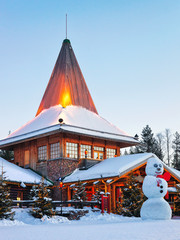 Wall Mural - Snowman at Santa Office in Santa Village Rovaniemi Lapland sunset