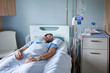 © marvent - Young man sleeping on a hospital bed with an intravenous drip