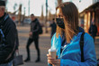 © sushytska - Coronavirus in Europe. the girl is standing by the road in a protective medical mask.