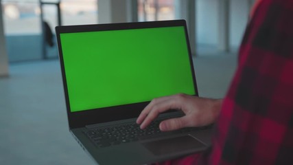 Wall Mural - Man hands engineer using laptop computer with green screen inside building worker project occupation builder technology mock-up professional male safety device computer slow motion
