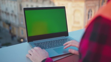 Wall Mural - Young hands man engineer using laptop computer with green screen on balcony worker project occupation builder technology mock-up professional male safety device computer slow motion