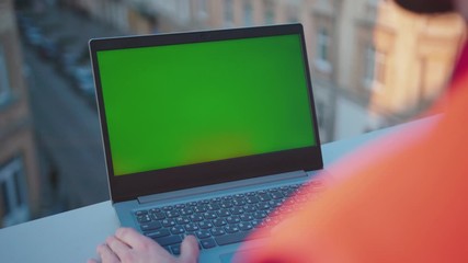 Wall Mural - On balcony man hands engineer using laptop computer with green screen worker project occupation builder technology mock-up professional male safety device computer slow motion