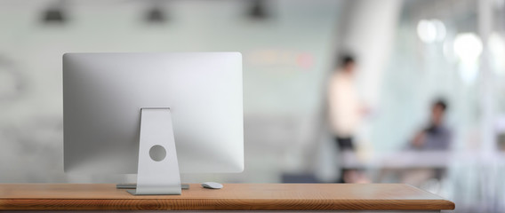 Cropped shot of comfortable workspace with computer device and copy space in glass wall office