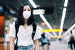 © thanakorn - Asian travelers girl with surgical face mask to protection the covid-19 in airport