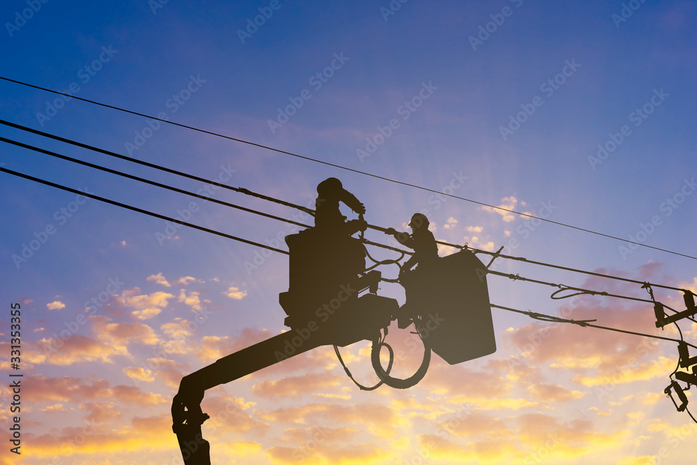 silhouette maintenance of electricians work with high voltage electricity on the hydraulic bucket - obrazy, fototapety, plakaty 