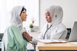 © Art_Photo - Muslim asian woman doctor service help support discussing and consulting hold stethoscope exam muslim woman patient and check up information at meeting health medical care concept in hospital