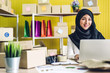 © Art_Photo - Portrait of smiling beautiful muslim owner asian woman freelancer sme business online shopping working on laptop computer with parcel box on table at home - Business online shipping and delivery