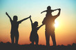 © Janpen - Silhouette of a family comprising a father, mother and two children happy family the sunset.Concept of friendly