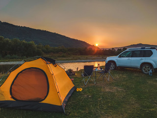 car travel concept camping place near mountains river