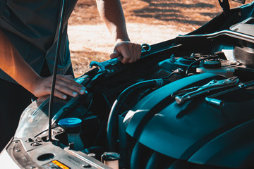 Machanic holding wrench in the repair garage,Car maintenance concept