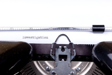 Fototapete - Word Investigation typed on retro black typewriter