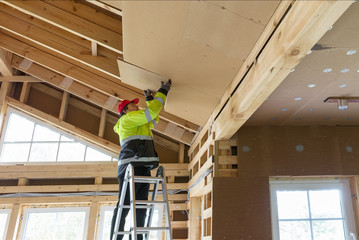 Construction worker thermally insulating eco wooden frame house