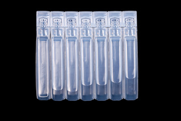 Poster - white plastic ampoules with medicine isolated on black background