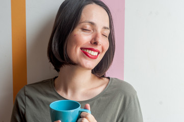 young peaceful happy woman drinking a beverage