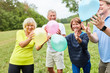 © Robert Kneschke - Seniors play with colorful balloons