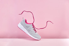 Pair Of Fashion Stylish Sneakers With Flying Laces, Running Sports Shoes On Pink Background