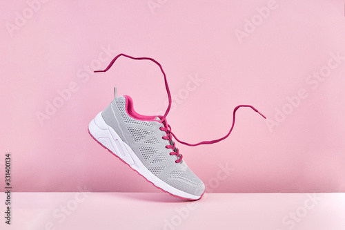 Fotografía Pair of fashion stylish sneakers with flying laces, Running sports shoes on pink