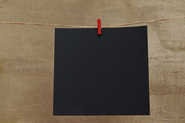 one large sheet of black paper on a rope with a clothespin