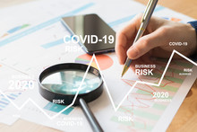 Businessman Works With Documents A Business Risk Chart Due To A Coronovirus Pandemic. Business Risks Covid-19