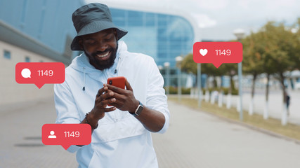 Portrait of Attractive African American Smiling Man in Stylish Look Checking News on Smartphone. Vlogger Influencer. Animation with User Interface - Likes, Followers, Comments for Social Media from